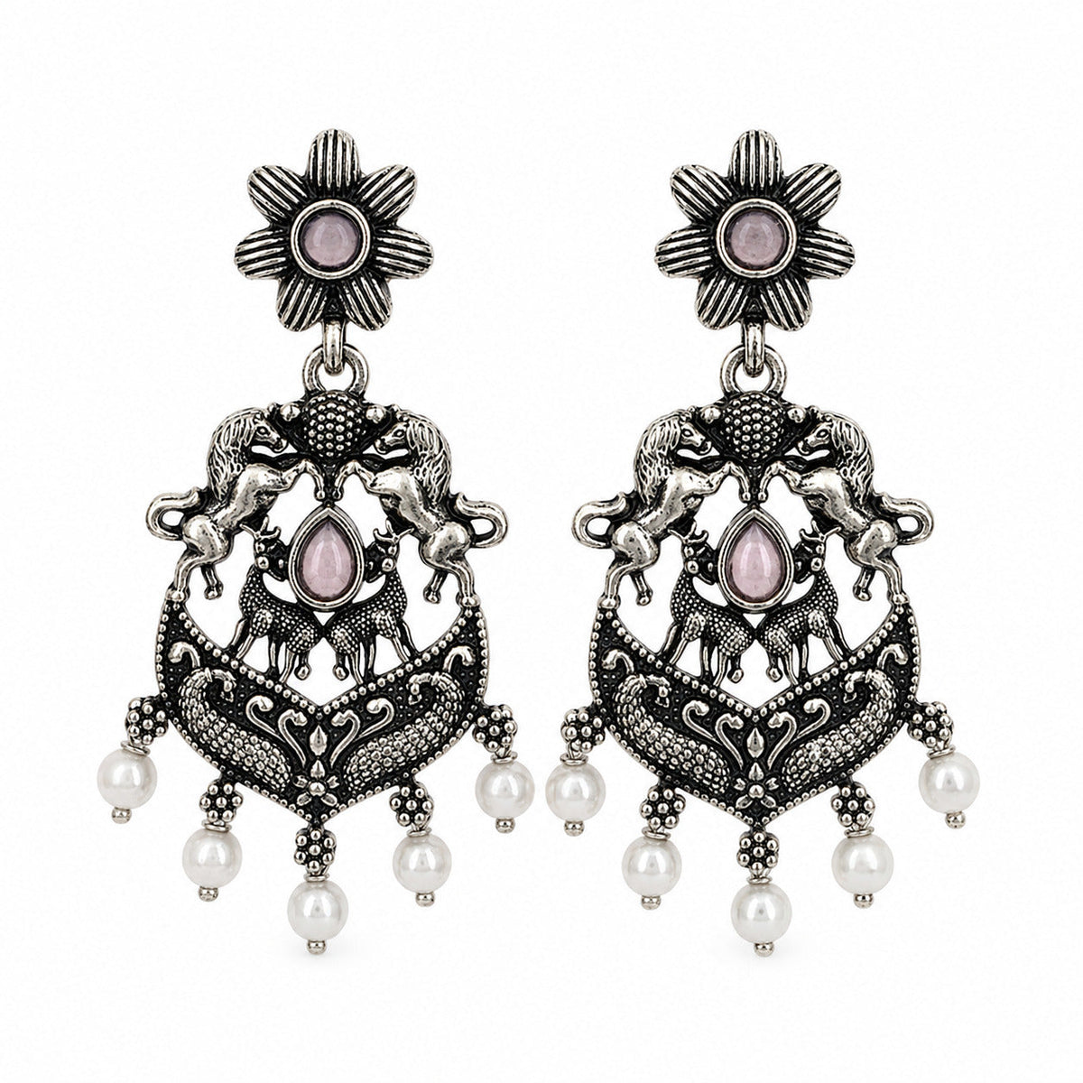 Oxidised silver chandbali earrings with horse and deer motifs beside a tiered jhumka
