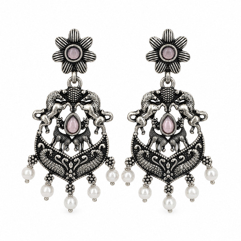 Oxidised silver chandbali earrings with horse and deer motifs beside a tiered jhumka
