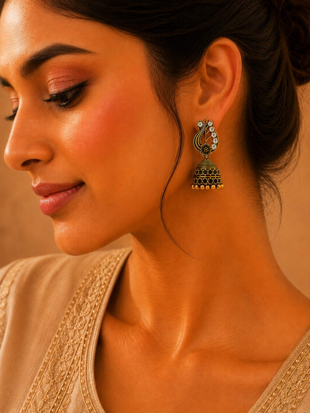 Model wearing antique gold peacock jhumka earrings with saree