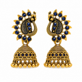 Antique gold peacock jhumka earrings with blue stones on white background