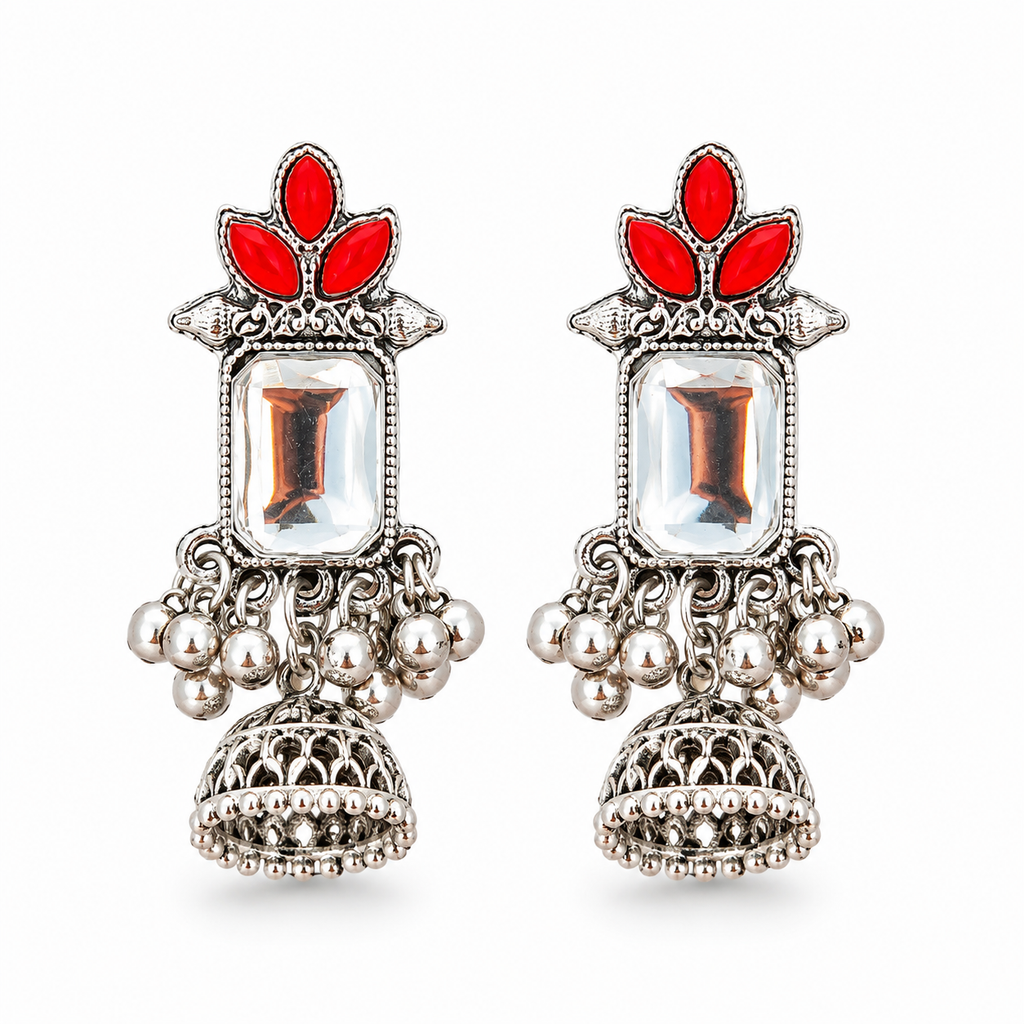 Oxidised silver jhumka earrings with red stones and clear crystal on white background