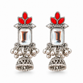 Oxidised silver jhumka earrings with red stones and clear crystal on white background