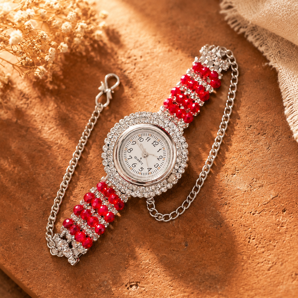 Crystal bracelet watch with red beads styled on terracotta surface