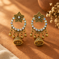 Antique gold star jhumka earrings with rainbow crystal hoop on terracotta