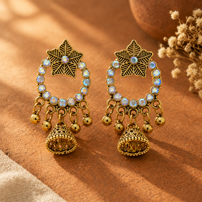 Antique gold star jhumka earrings with rainbow crystal hoop on terracotta