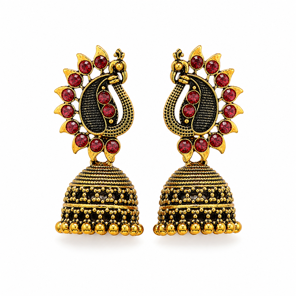 Antique gold peacock jhumka earrings with red stones on white background