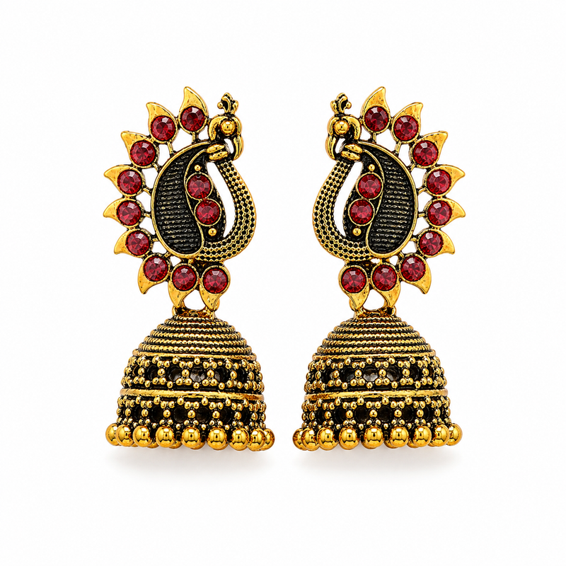 Antique gold peacock jhumka earrings with red stones on white background