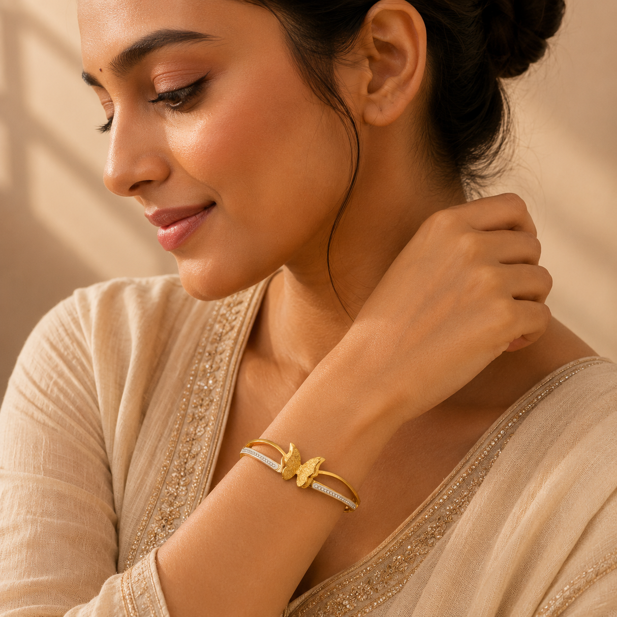 Model wearing golden butterfly bangle bracelet with saree