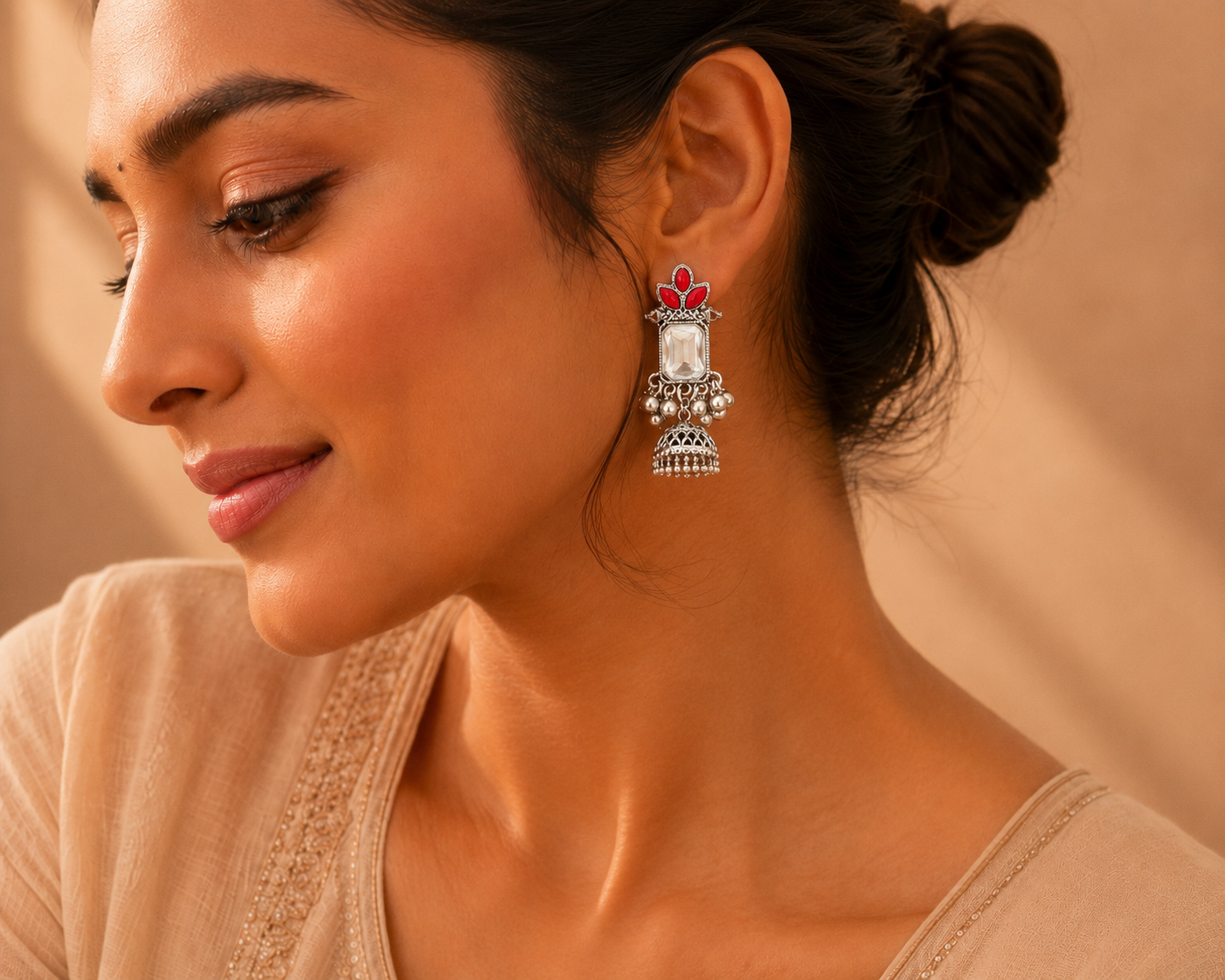 Model wearing oxidised silver red stone jhumka earrings with saree