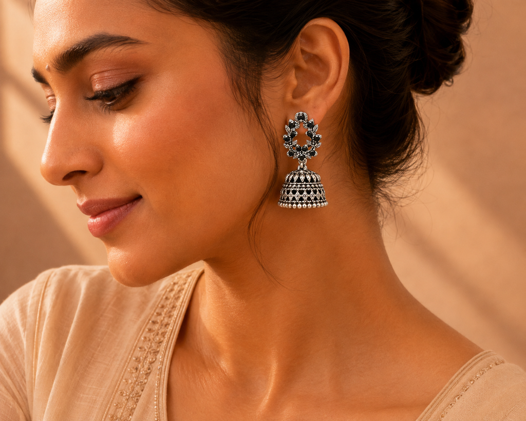 Model wearing oxidised silver black stone leaf wreath jhumka earrings