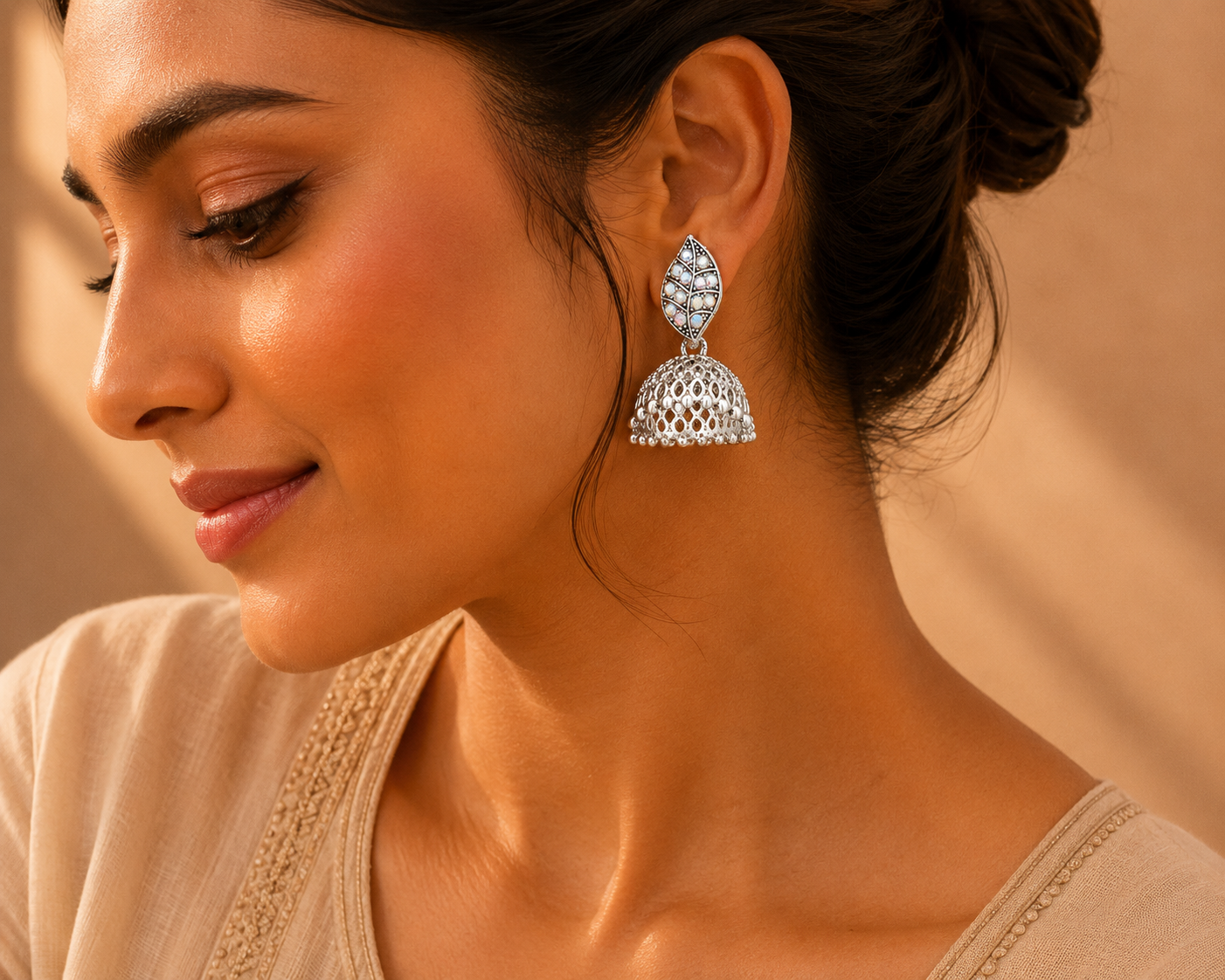 Model wearing oxidised silver leaf jhumka earrings with saree