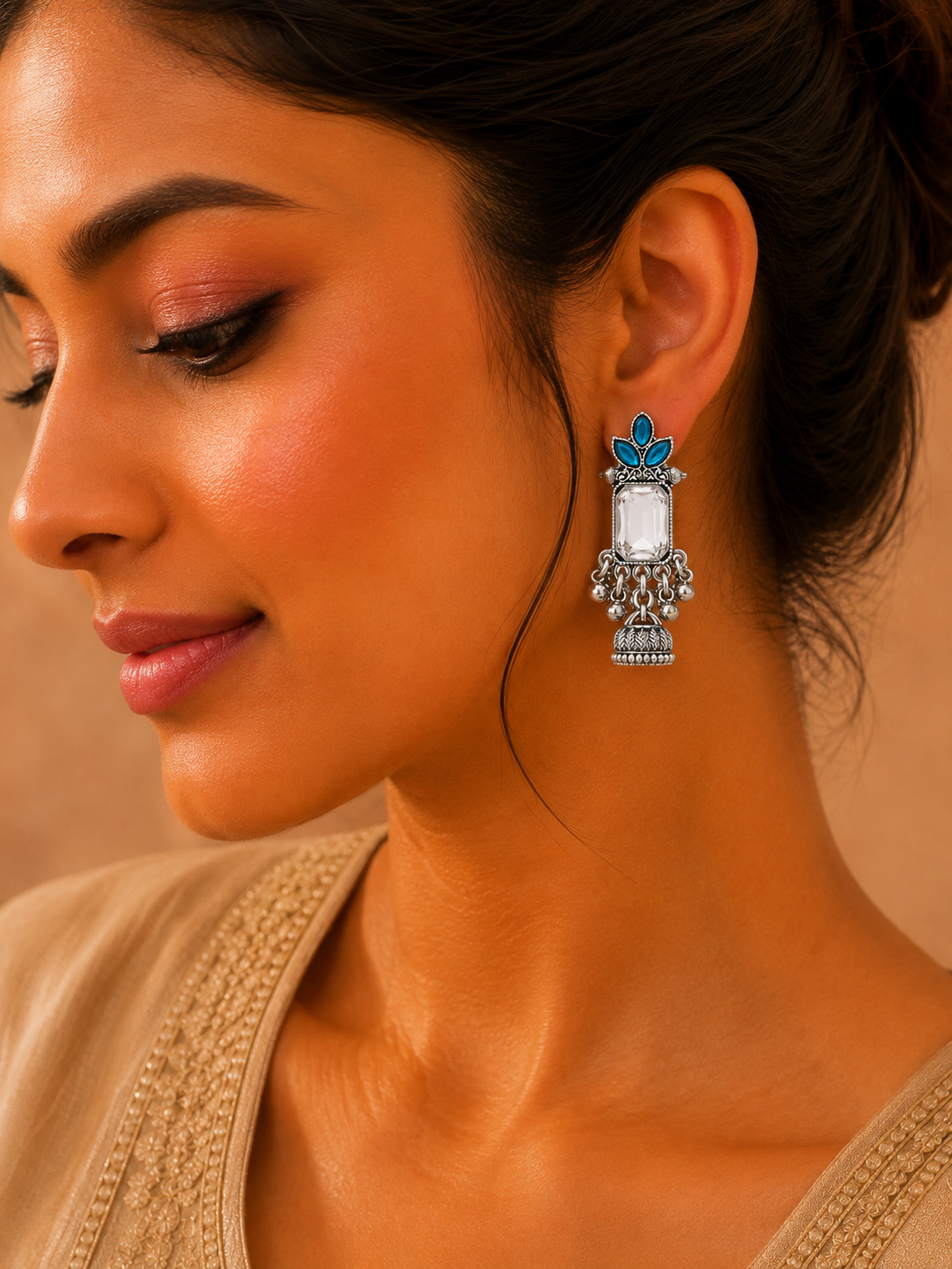 Model wearing oxidised silver blue stone jhumka earrings with saree