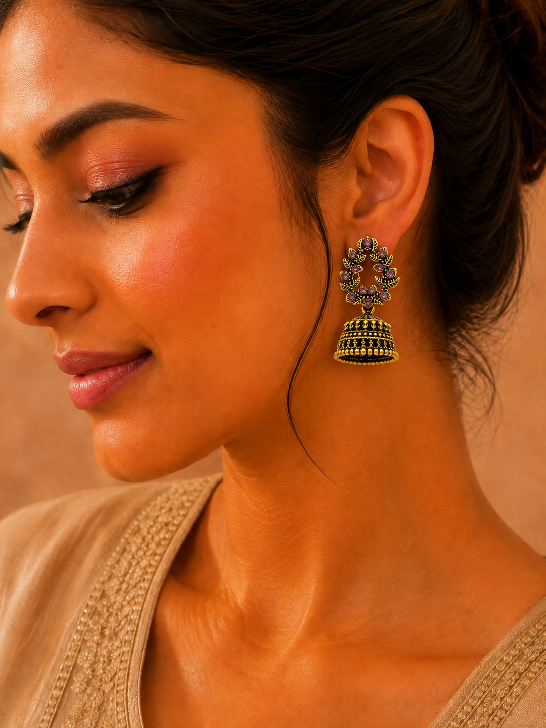 Model wearing antique gold purple stone jhumka earrings with saree