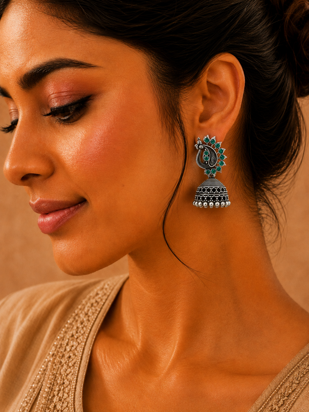 Model wearing oxidised silver green stone peacock jhumka earrings