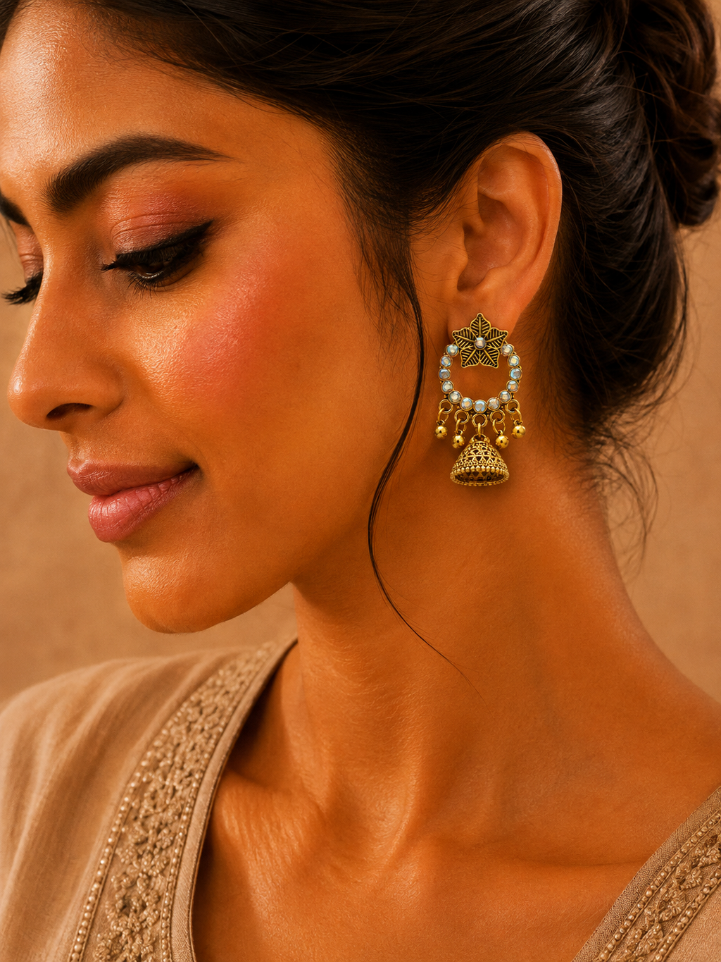 Model wearing antique gold star jhumka earrings with saree