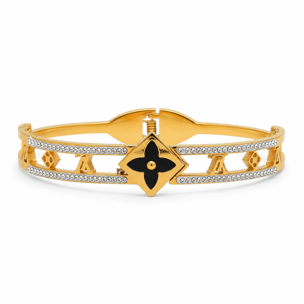 Gold-tone crystal bangle with black four-petal centrepiece statement bracelet