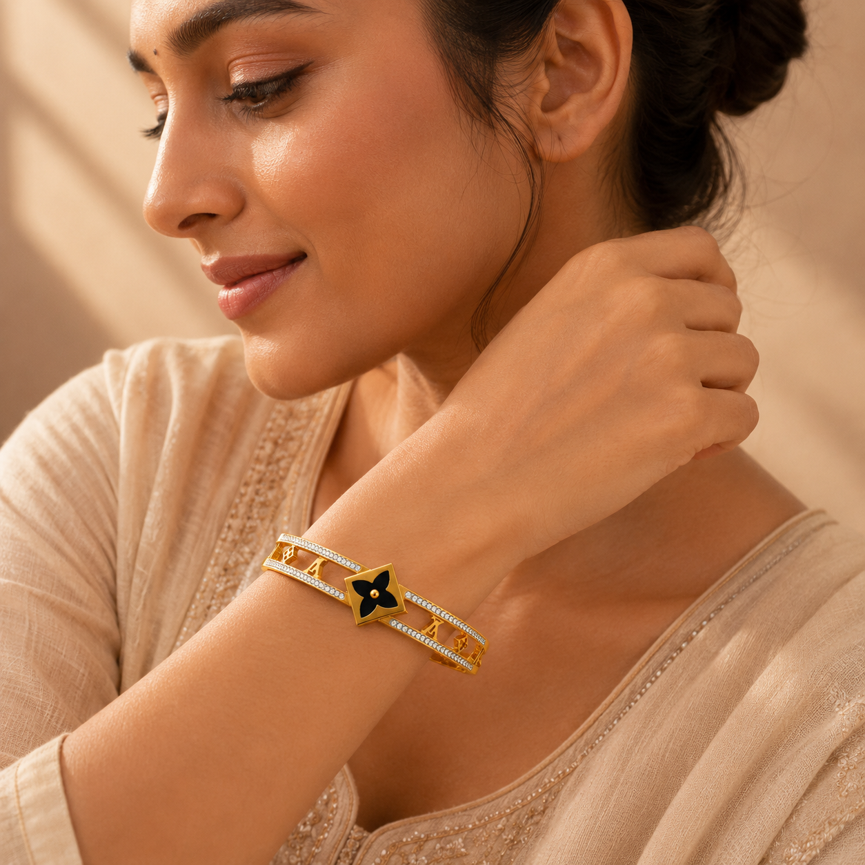 Gold-tone crystal statement bangle worn on a wrist