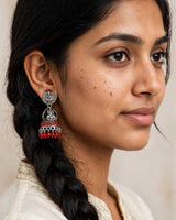 Oxidised Silver Lakshmi Temple Jhumka Earrings with Red Bead Drops