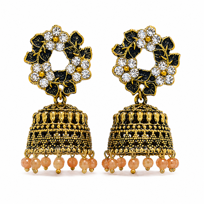 A pair of traditional Indian gold-plated jhumka earrings with black enamel floral motifs, clear crystal rhinestones, and dangling peach-colored glass beads, shown on a plain white background.