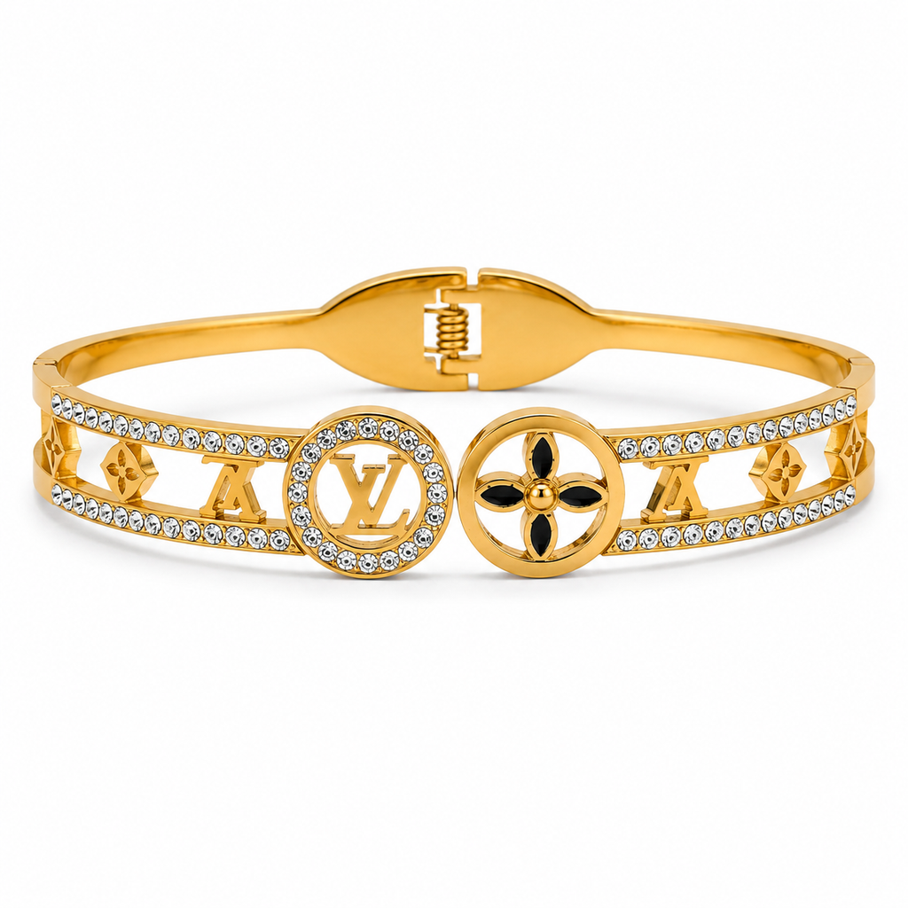 Gold-tone openwork bangle bracelet with crystal-studded cut-out design